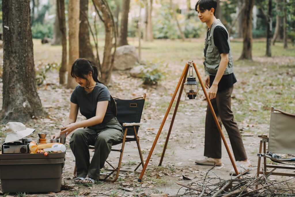 Asian couple sweet in tent inside on they camping trip, traveller relax and sleep togather in out door and camping trip Stock Free