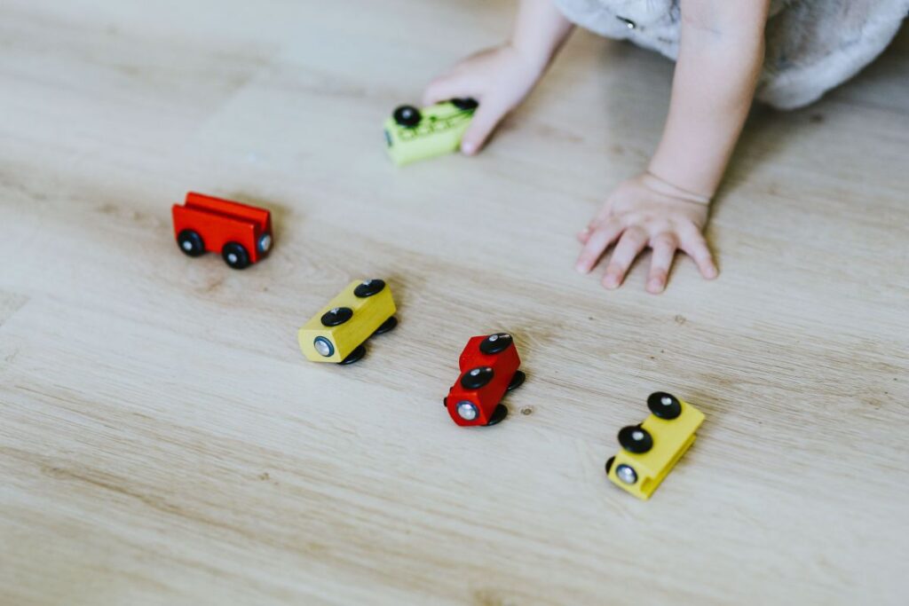 
									Child playing with toys on the floor Stock Free