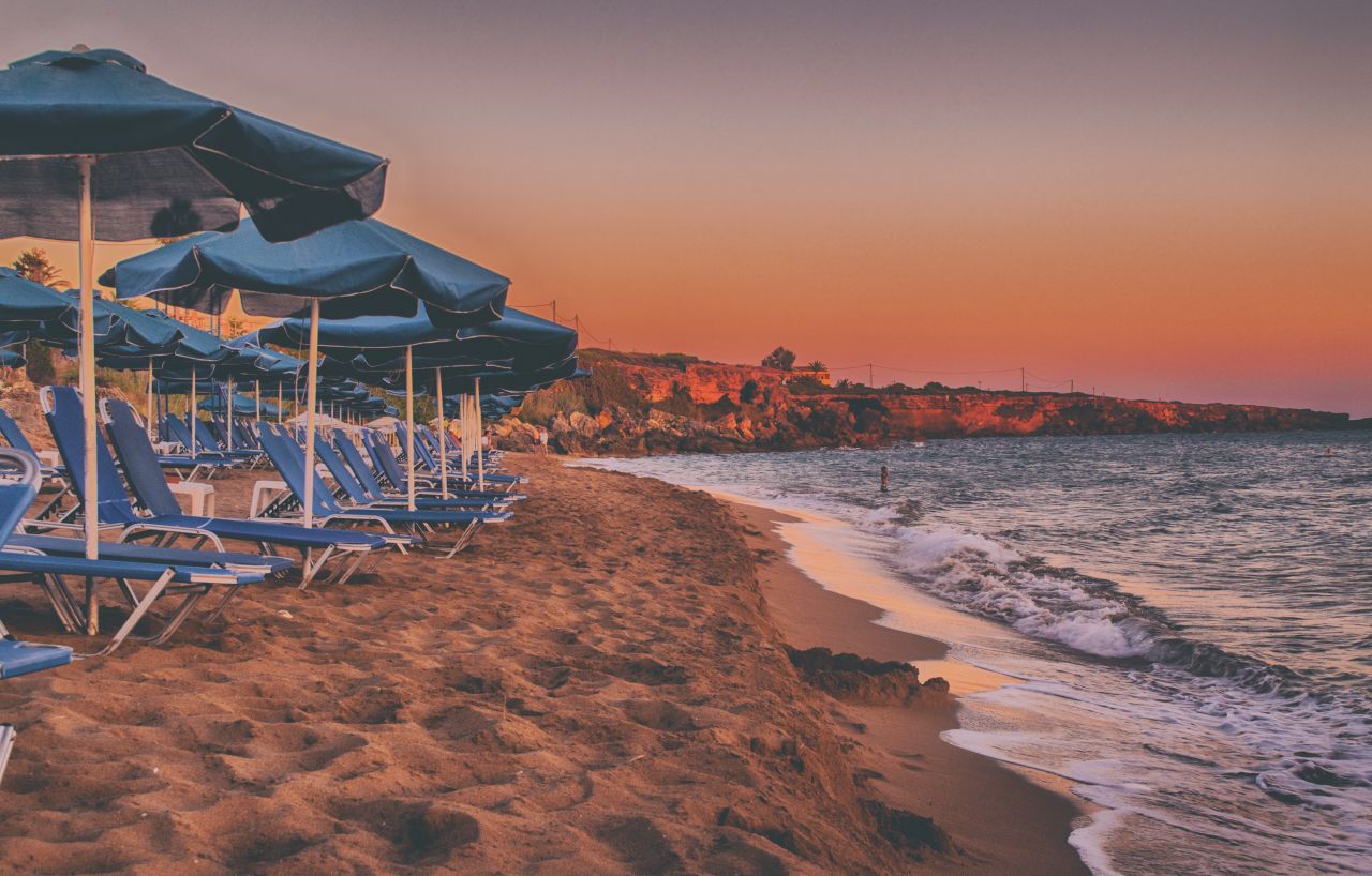 Sunset by the Sea with Umbrella and Sunbeds in Ammes Beach, Greek Island of Kefalonia Stock Free