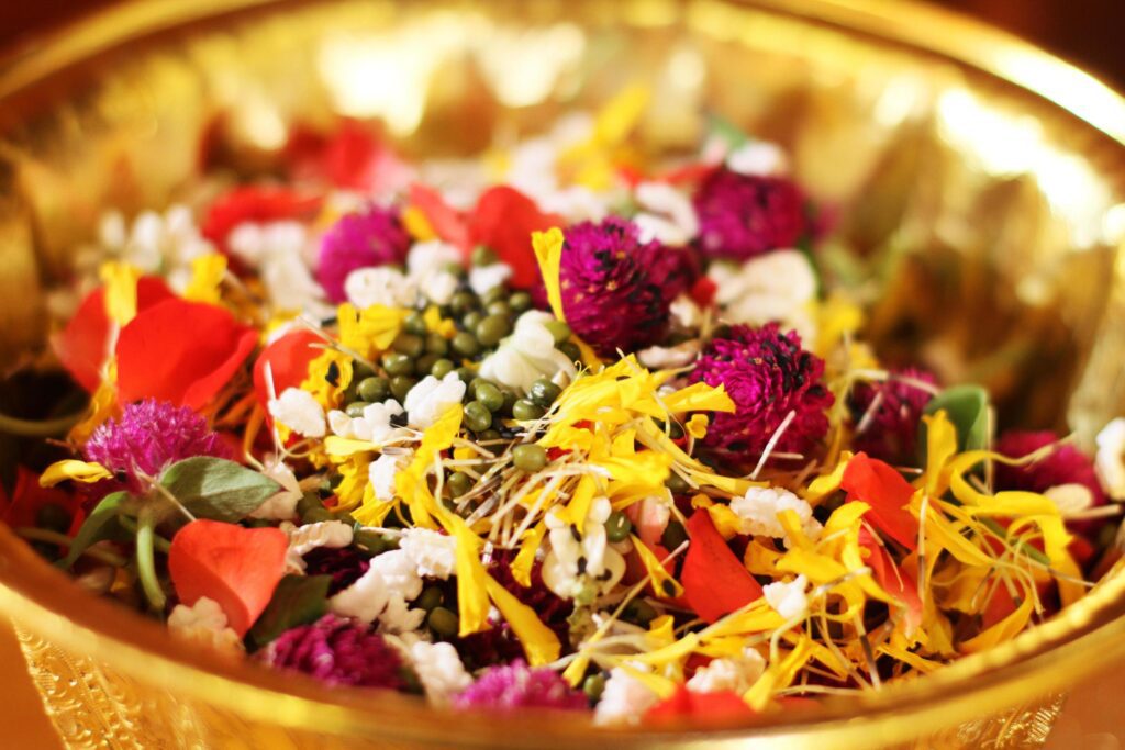 Red rose and Marigold flowers petals in gold tray in tradition Thai wedding ceremony and Buddhism in the temple Stock Free