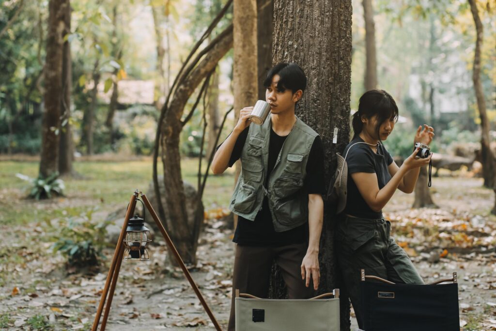 Asian couple sweet in tent inside on they camping trip, traveller relax and sleep togather in out door and camping trip Stock Free