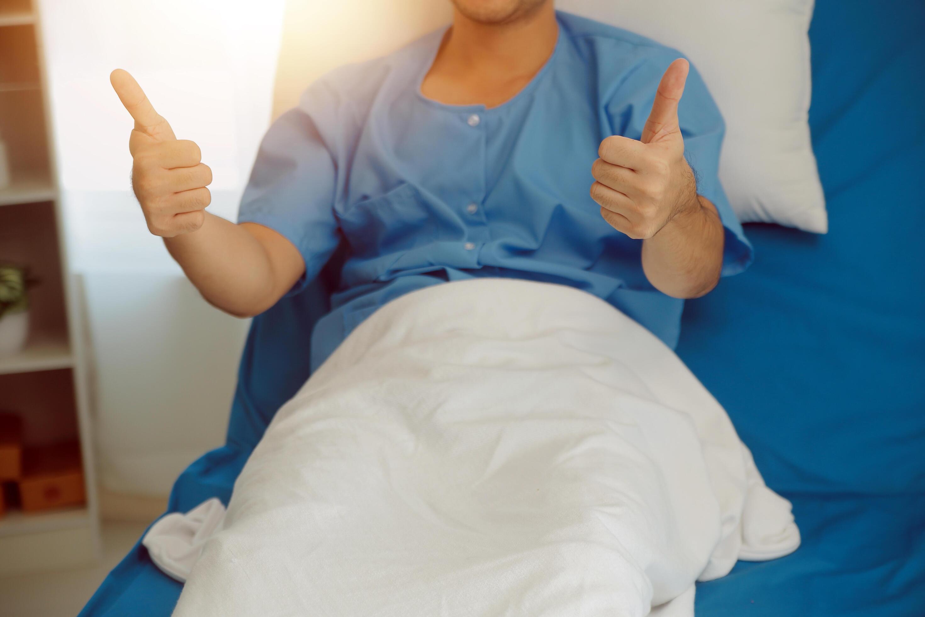 Portrait of happy caucasian sick patient on bed in hospital in medical and healthcare treatment at nursing home or clinic. People lifestyle Stock Free