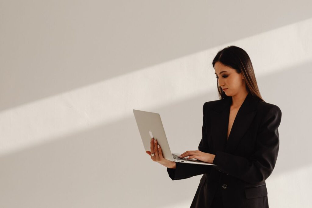 Dark Classy Aesthetic Fashion – Beautiful Asian Female Entrepreneur in Black Suit – Technology and Devices – iPhone – Laptop – AirPods Stock Free