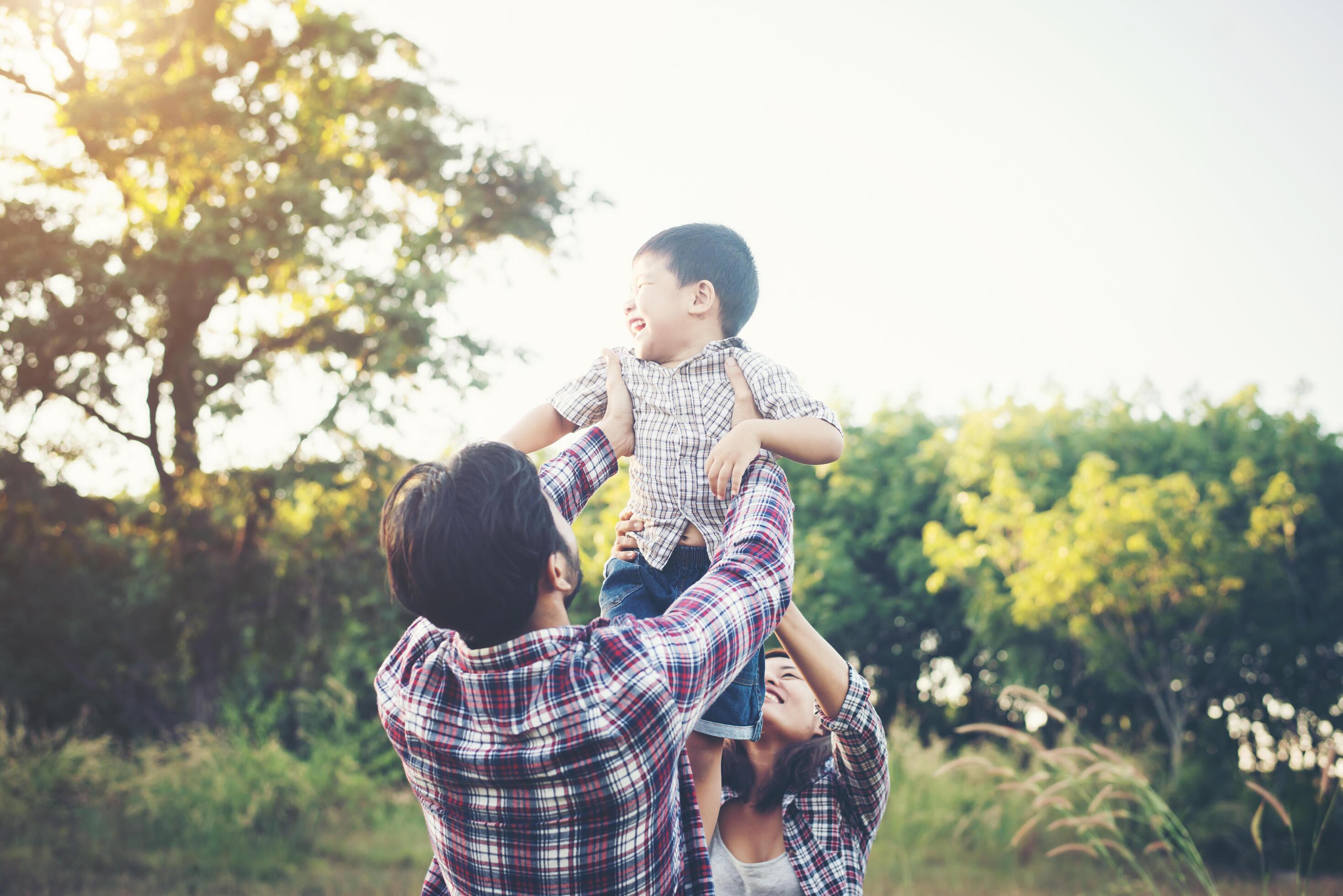 Happy young family spending time together outside in green nature park Stock Free