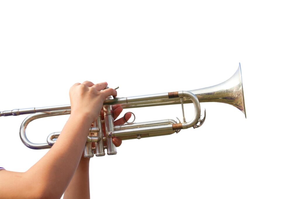 A cut-out of hands playing a trumpet on a white background with clipping paths. Stock Free