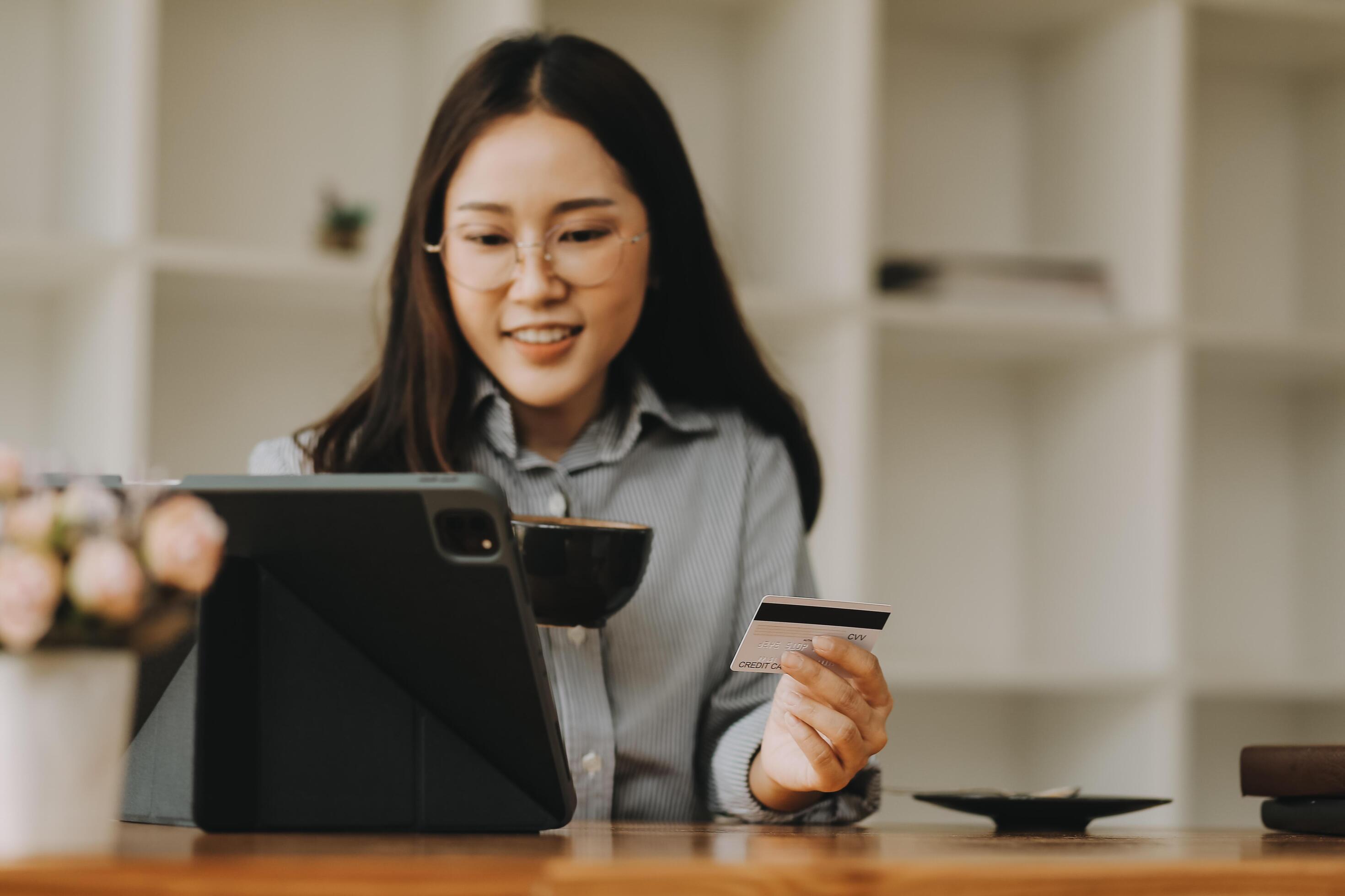 Happy asian woman using smartphone shopping online with credit card. Lifestyle. Easy pay using smart phone or digital device. Stock Free