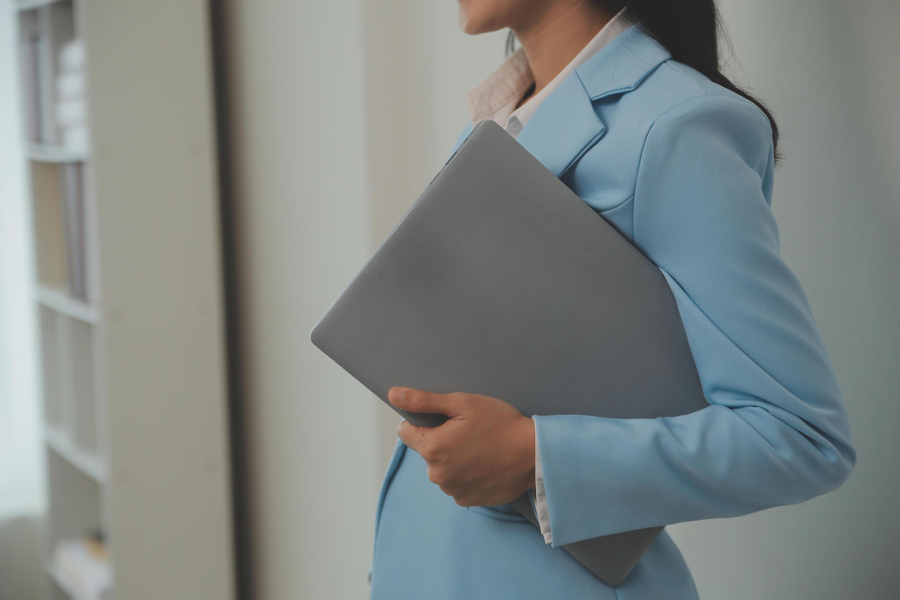 Portrait of a happy asian businesswoman working on laptop computer isolated over white background Stock Free