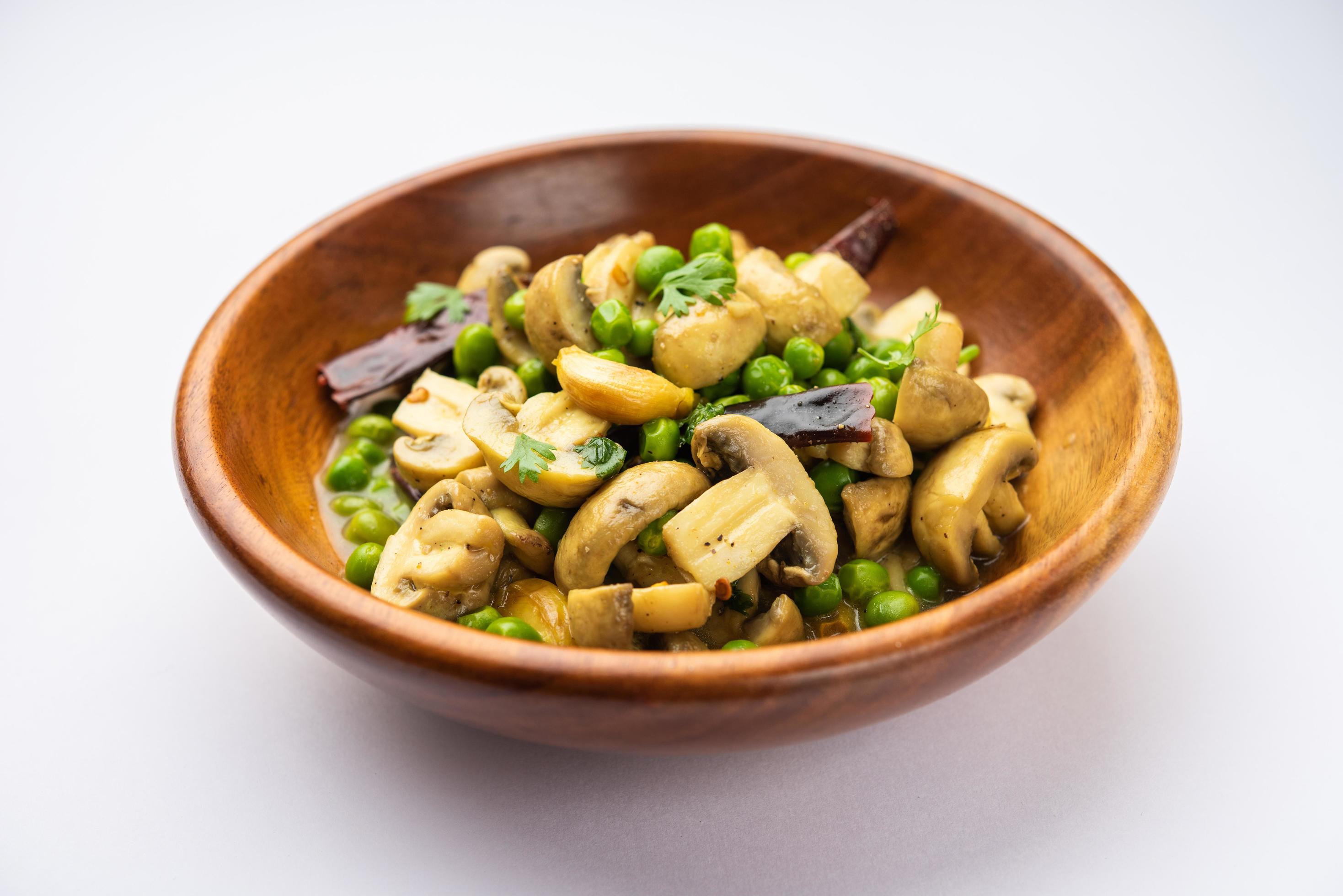 Mushroom and Pea Curry with Roasted Garlic, Indian food served in a bowl Stock Free