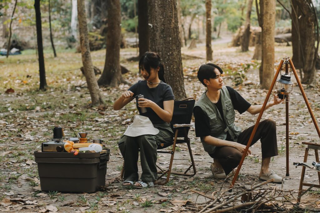 Asian couple sweet in tent inside on they camping trip, traveller relax and sleep togather in out door and camping trip Stock Free