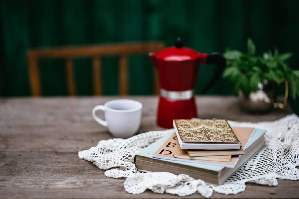 
									Stack of organizers and red italian coffee maker Stock Free