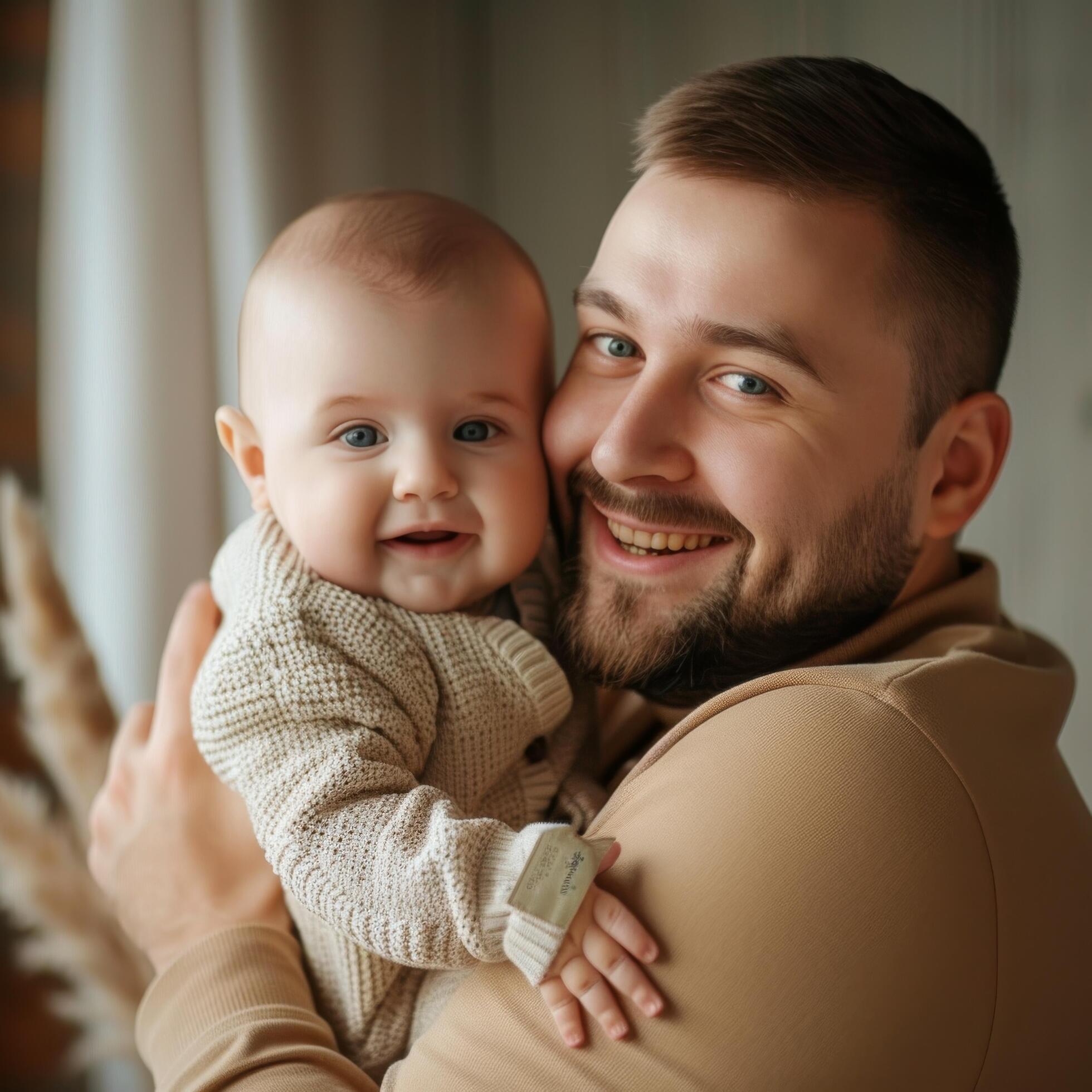 Father holding baby with warm and loving expression suitable for family-oriented content Stock Free