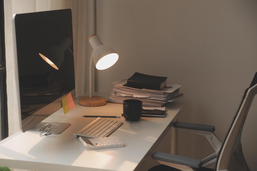 messy office workspace. Messy and cluttered office desk. Messy business office with piles of files and disorganized clutter. Stock Free