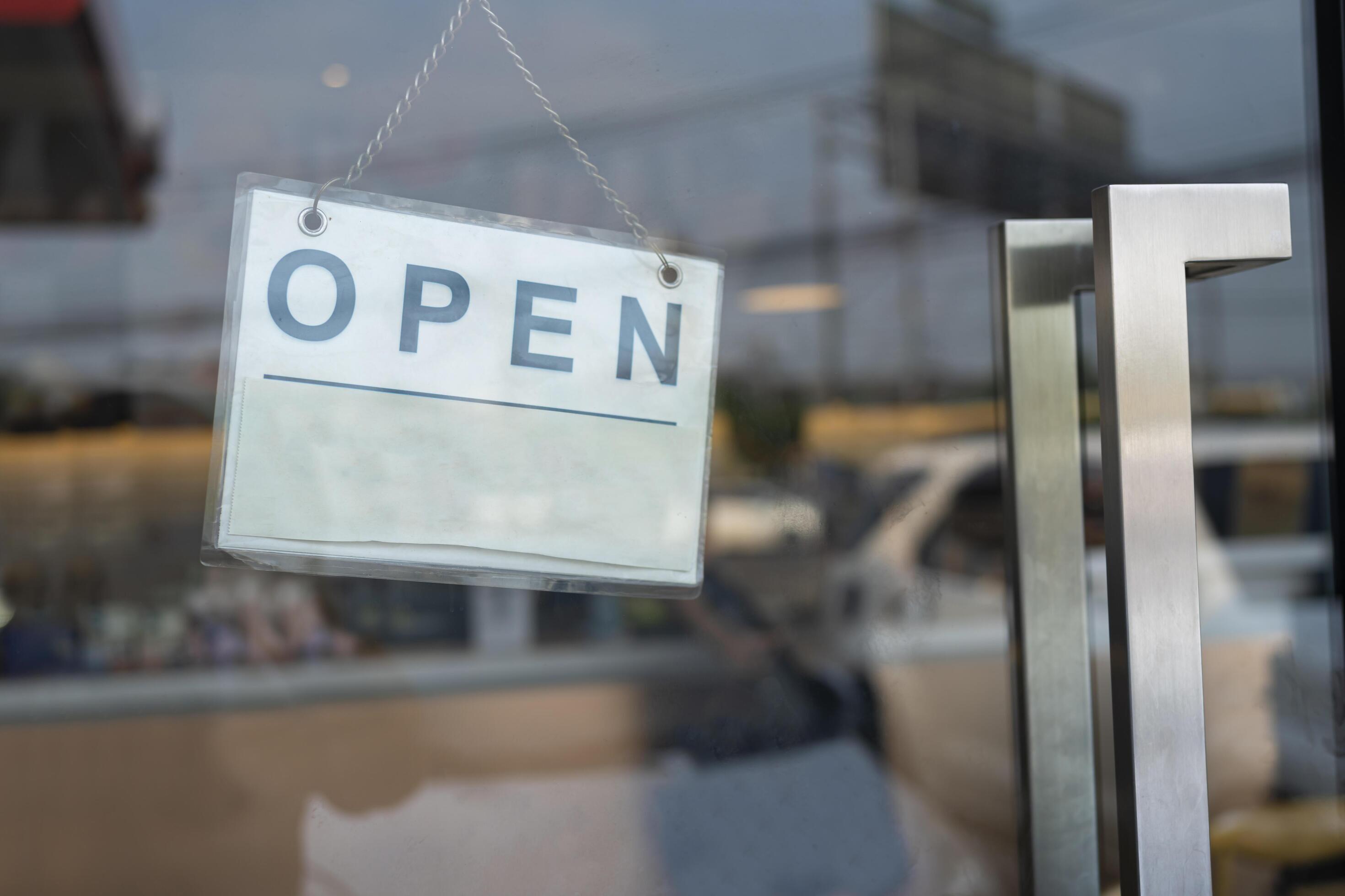 A business sign that says Open on cafe or restaurant hang on door at entrance. Stock Free