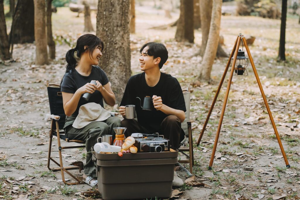 Asian couple sweet in tent inside on they camping trip, traveller relax and sleep togather in out door and camping trip Stock Free