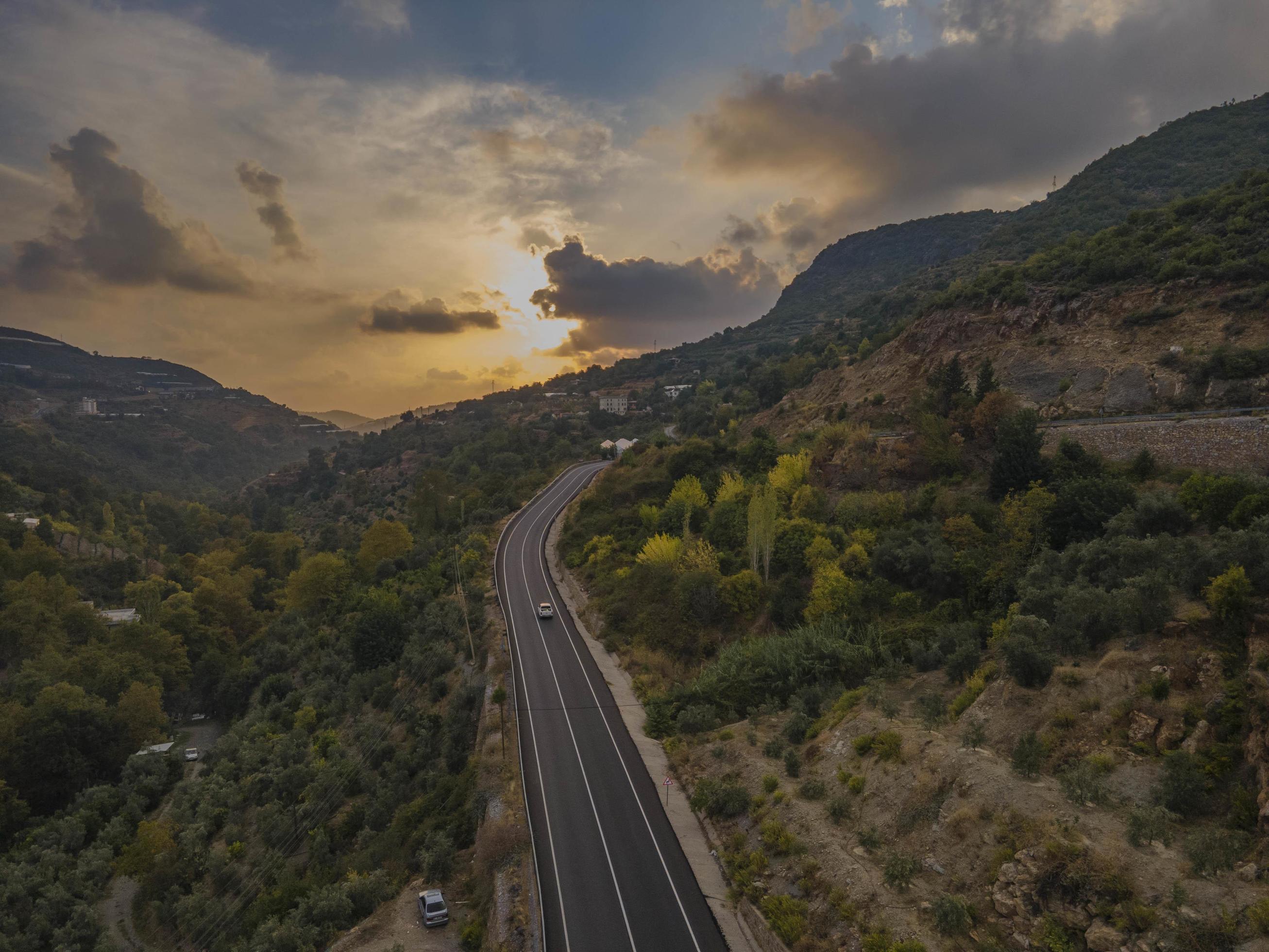 aerial valley and road, Top view, amazing nature background. sunset Flying drone, seascape Stock Free