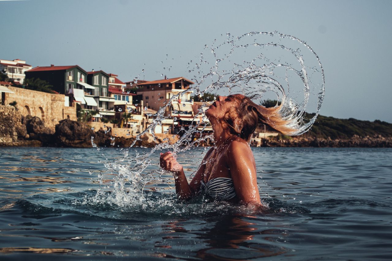 Girl Splashing Hair in the Sea with Mediterranean Background Stock Free