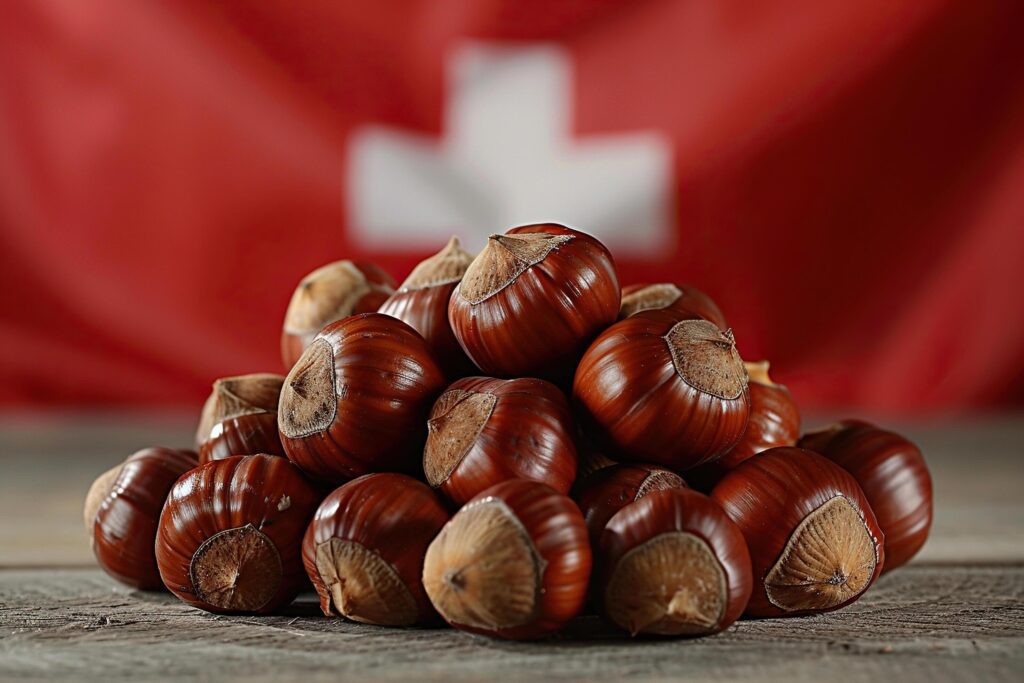 A bunch of chestnuts on wood against the background of the Swiss flag. Generated by artificial intelligence Stock Free