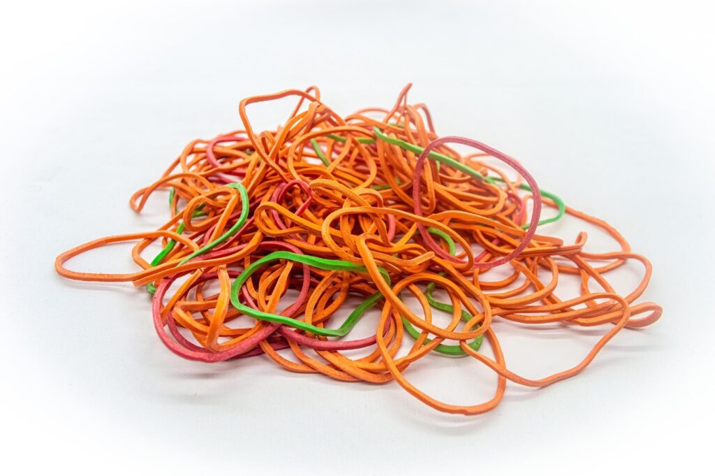 a bunch of messy rubber bands on a white background Stock Free