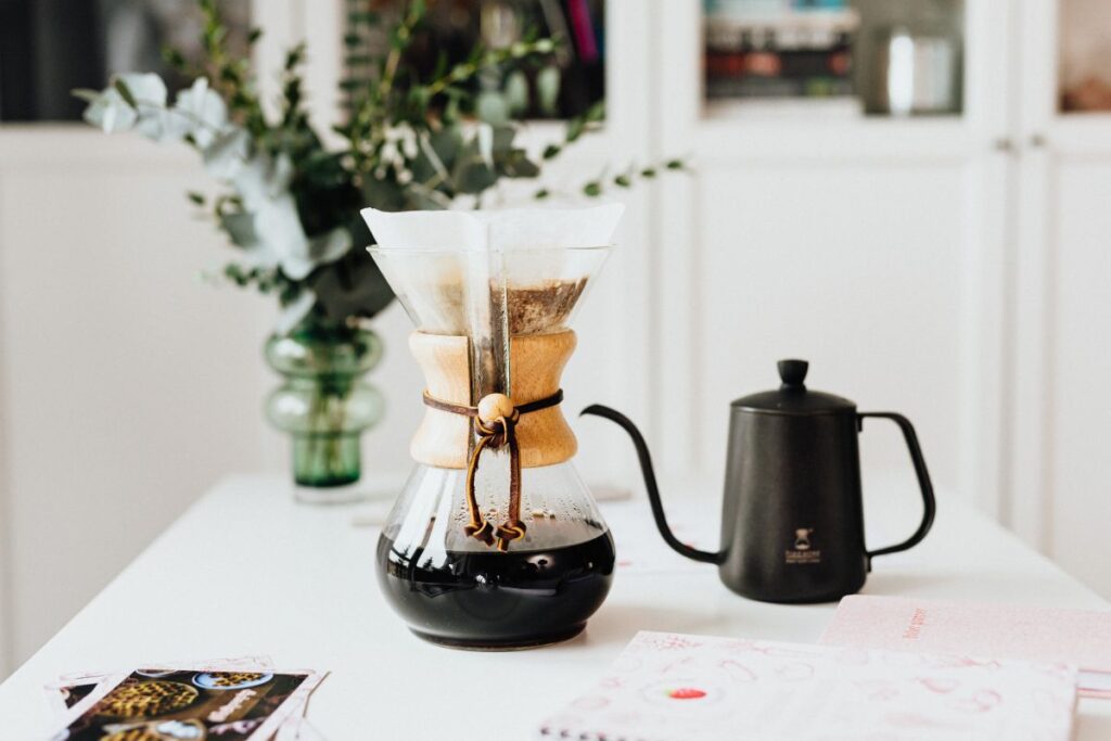 
									The woman drinks coffee and works at her desk Stock Free