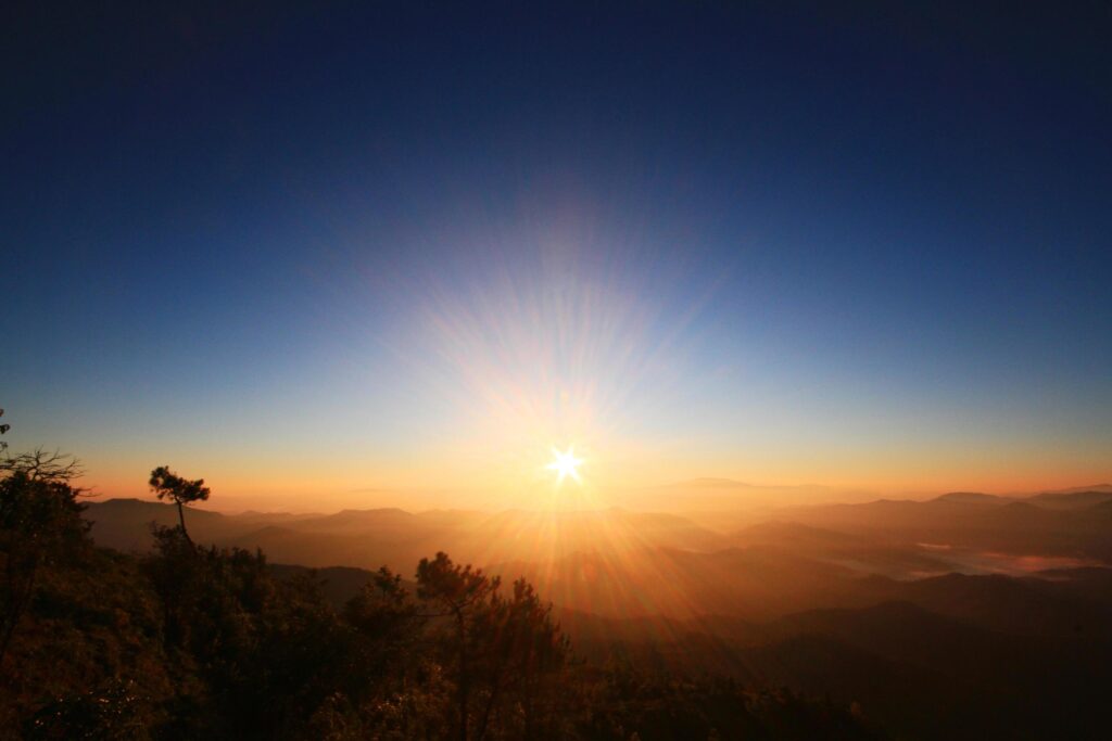 Beautiful golden natural sunlight and twiligh of sunrise shining to in the mist on valley of mountain in Thailand Stock Free