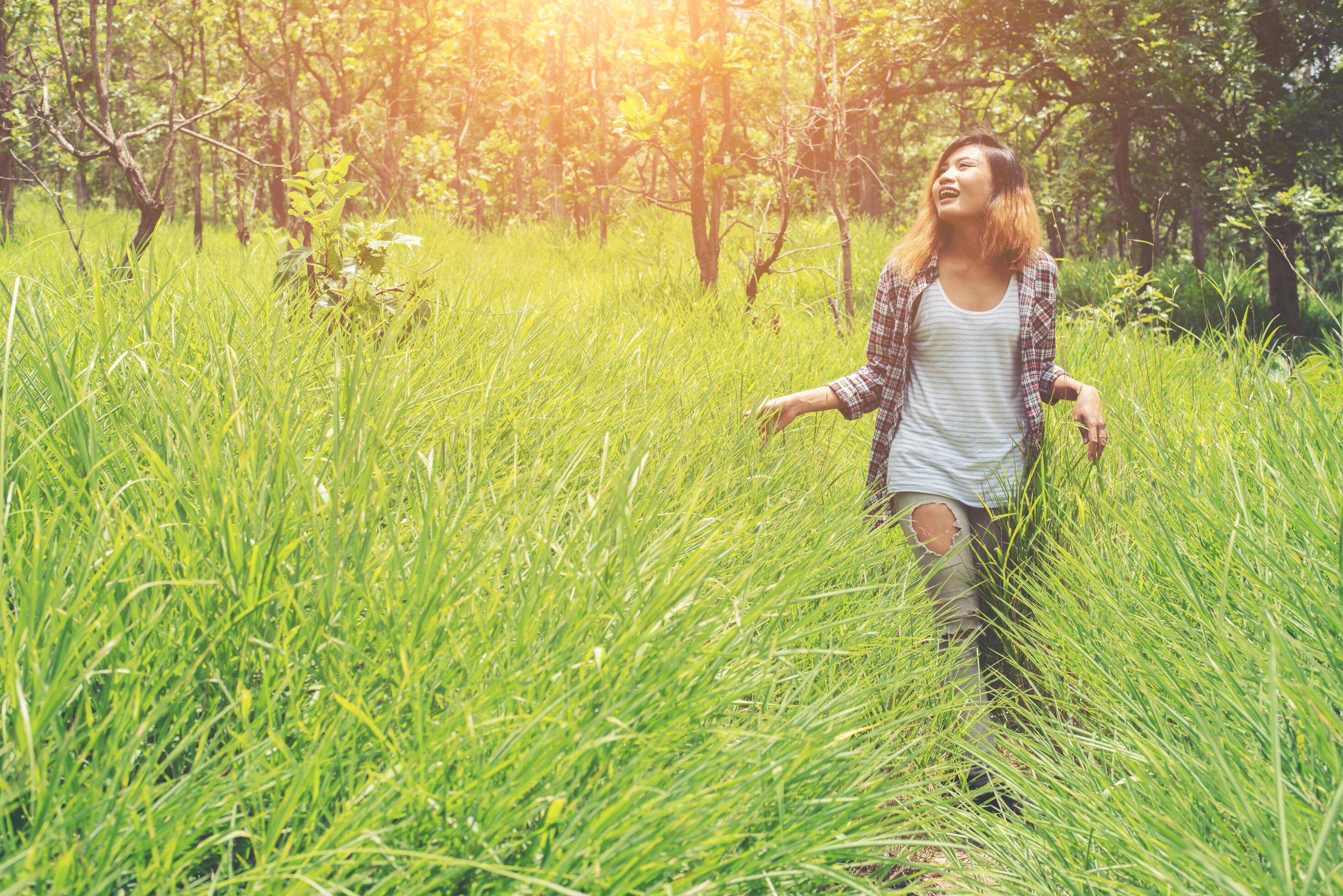 Young woman enjoying nature in the middle of a meadow, Freedom and relaxing. Stock Free