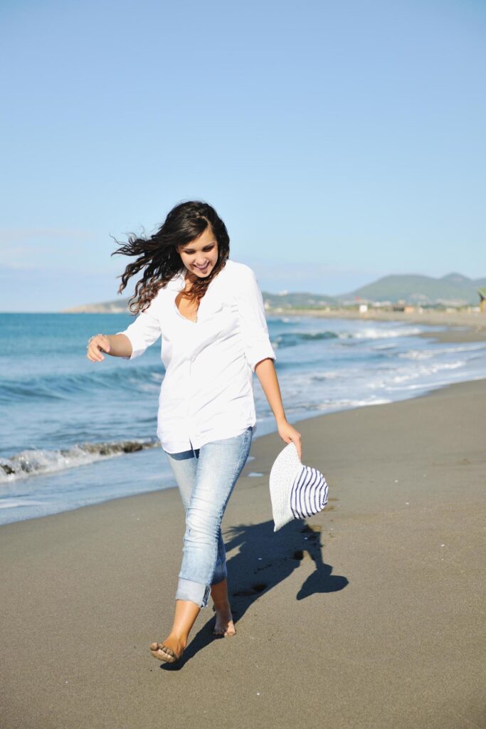 happy young woman on beach Stock Free