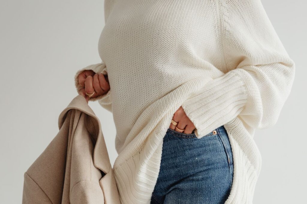 Woman in a white sweater – jewelry – laptop work – fashion Stock Free