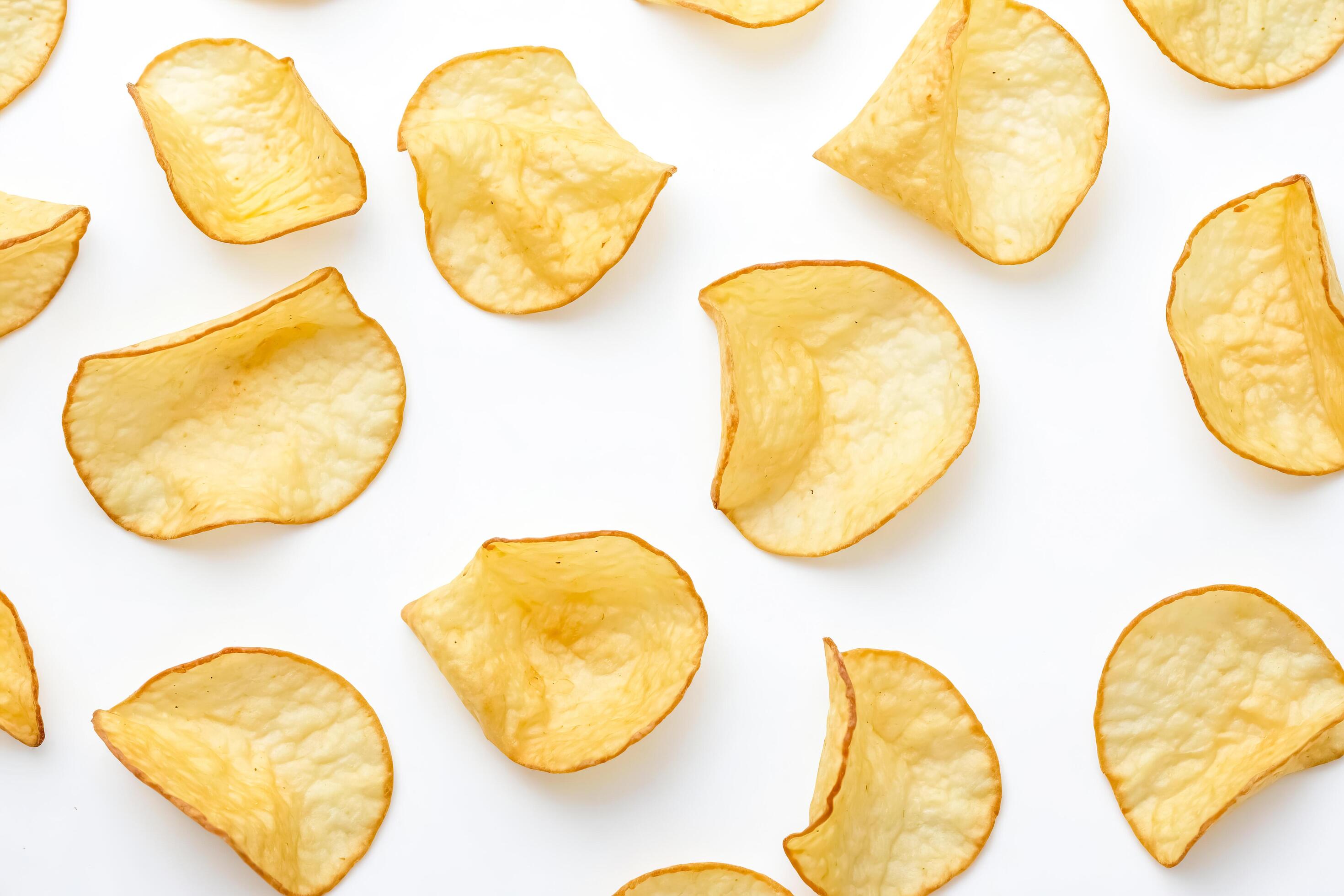 Crispy Potato Chips Scattered on White Background Stock Free