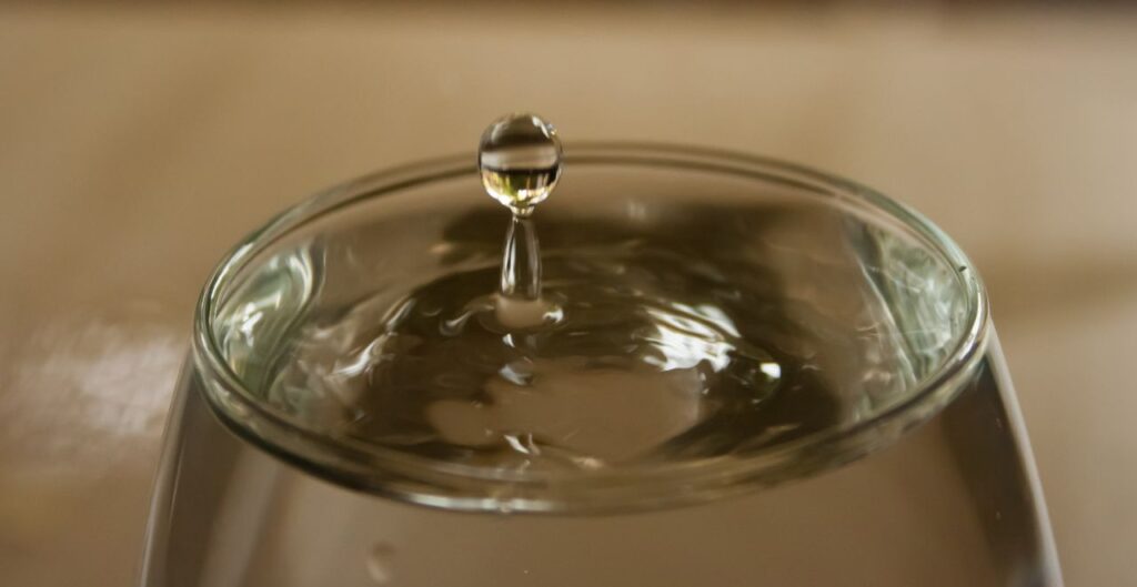 Water Drop Falling In Glass Stock Free