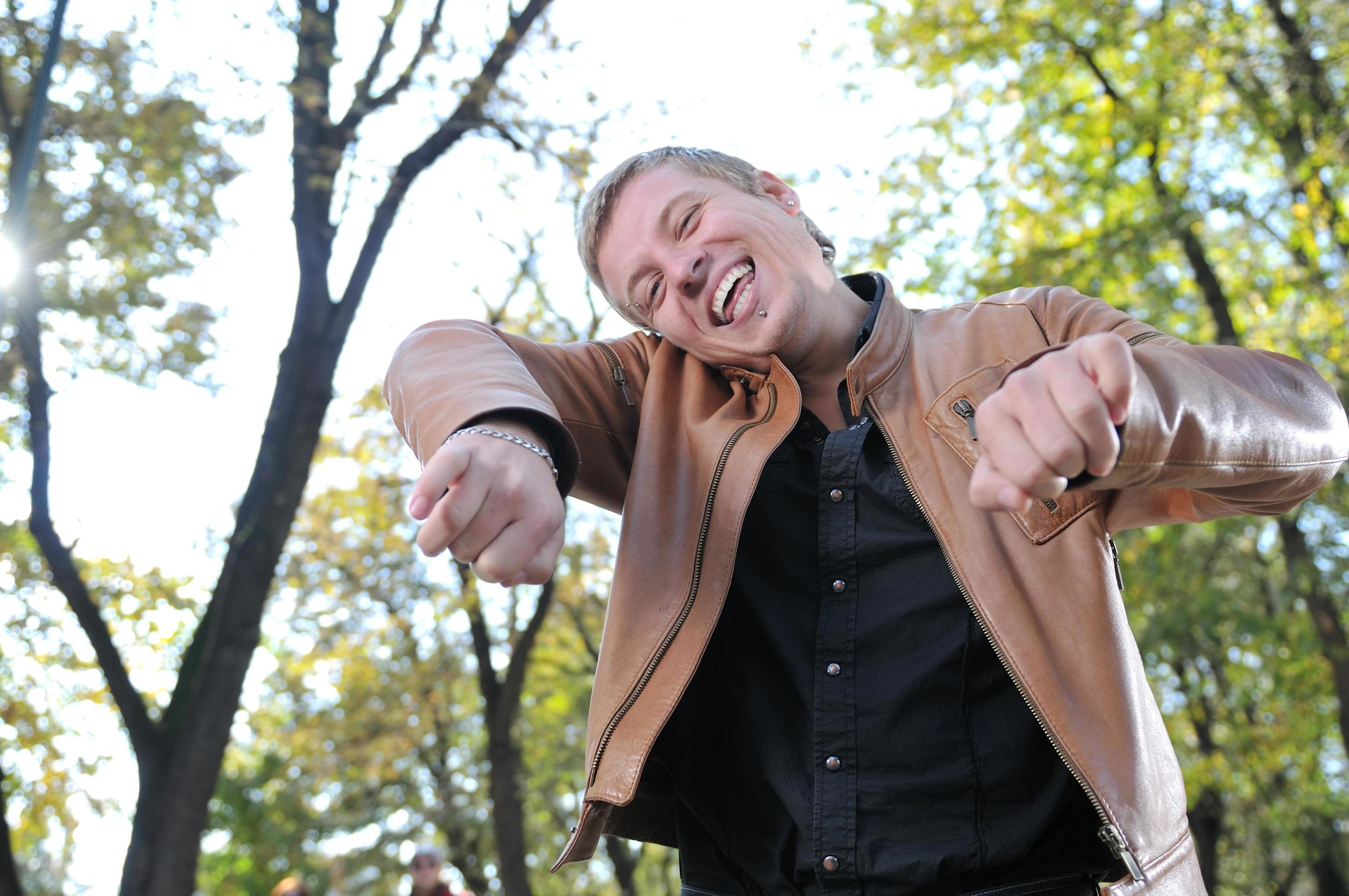 Handsome young man expressing his inner feeling outside in natur Stock Free