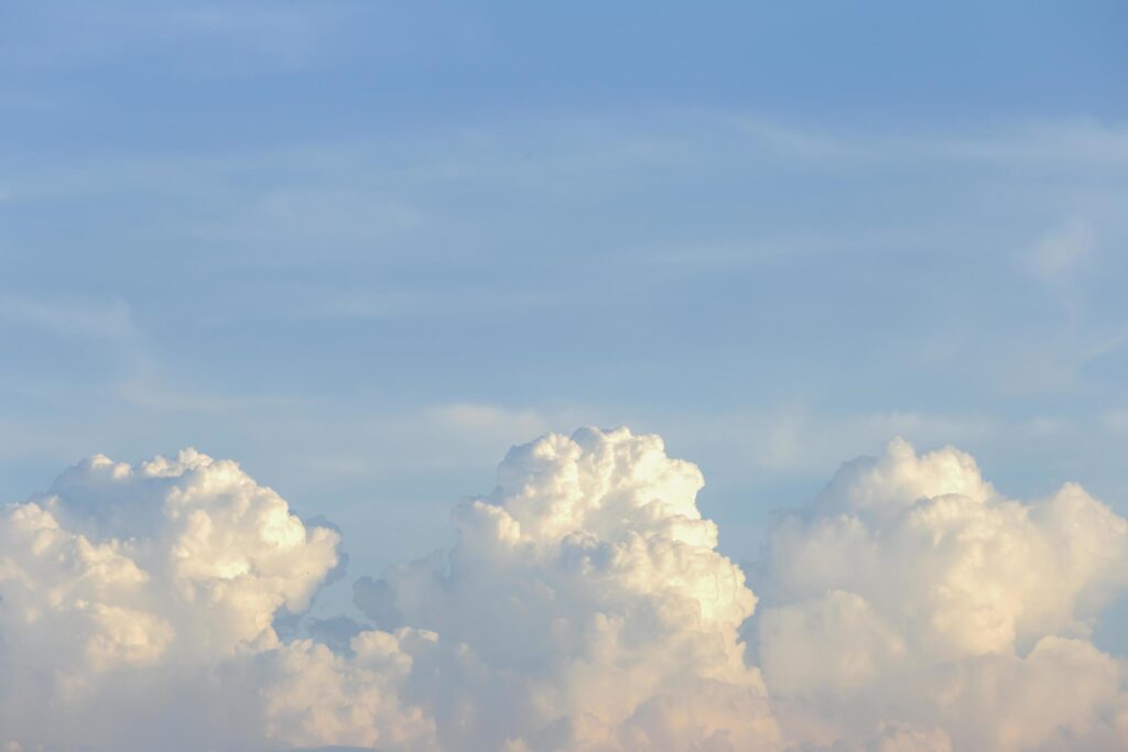 clear blue sky with plain white cloud with space for text background. The vast blue sky and clouds. blue sky background with tiny clouds nature. Stock Free