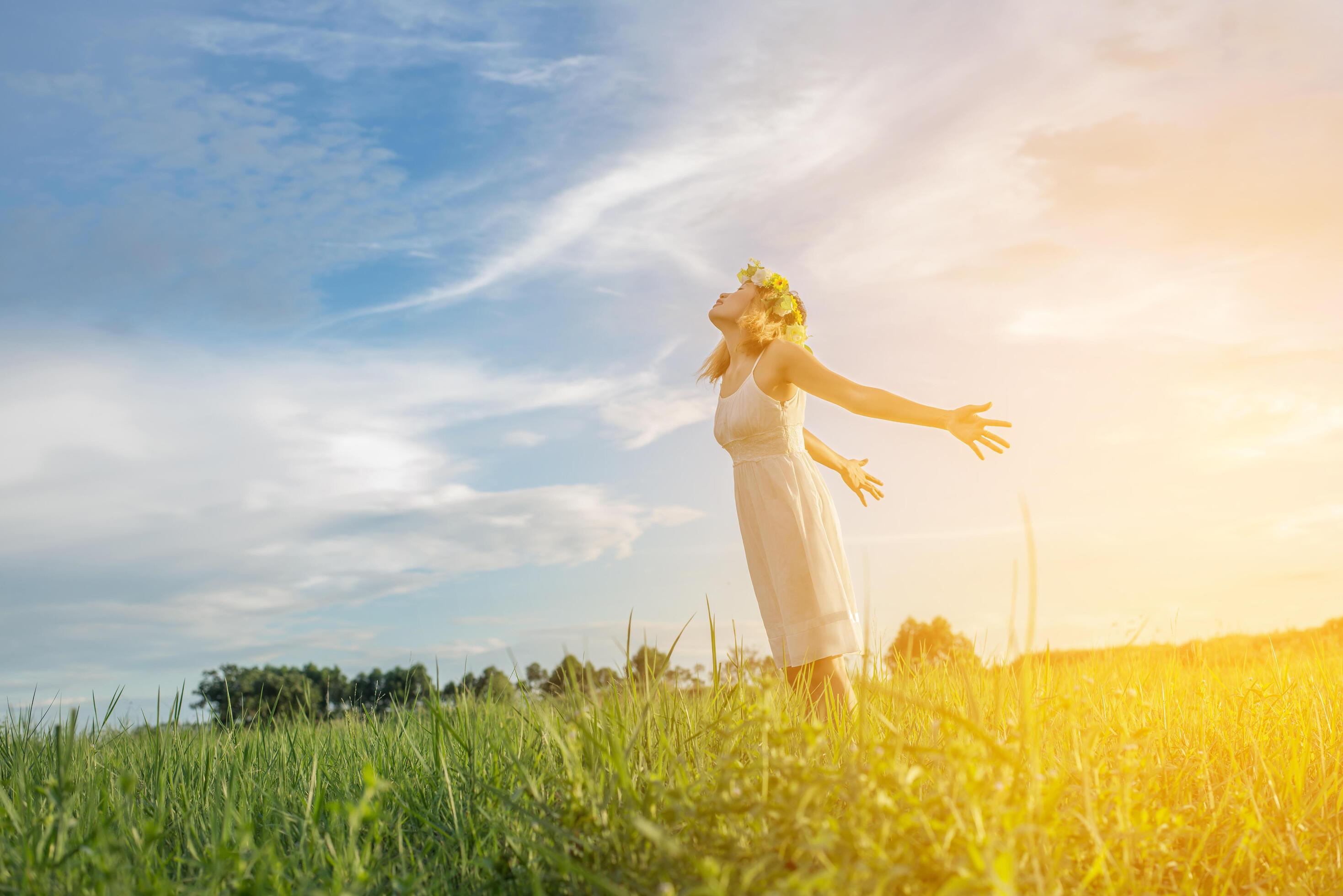 Freedom concept Young beautiful woman enjoying with fresh air and nature at meadows. Stock Free