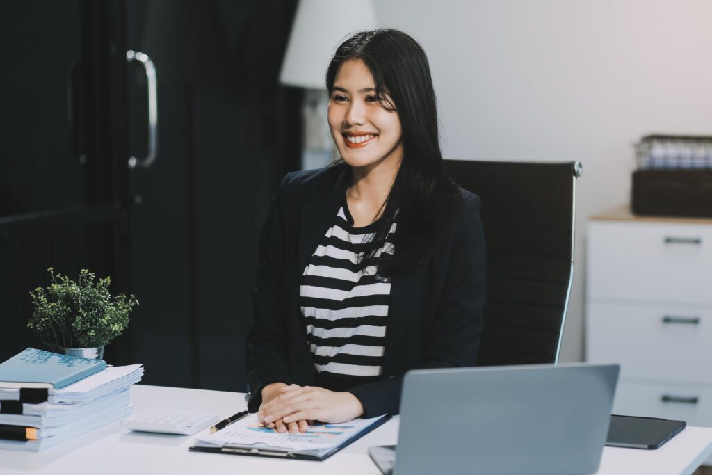 Young pretty business woman with notebook in the office Stock Free