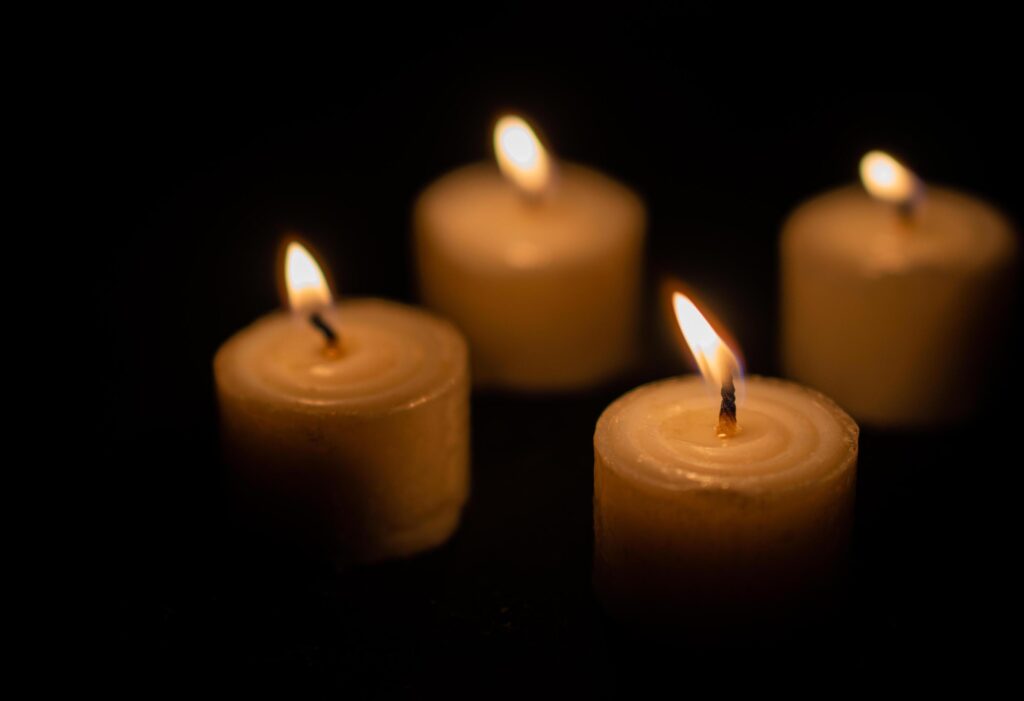 Candles light. Christmas candles burning at night. Abstract candles background. Golden light of candle flame. Stock Free