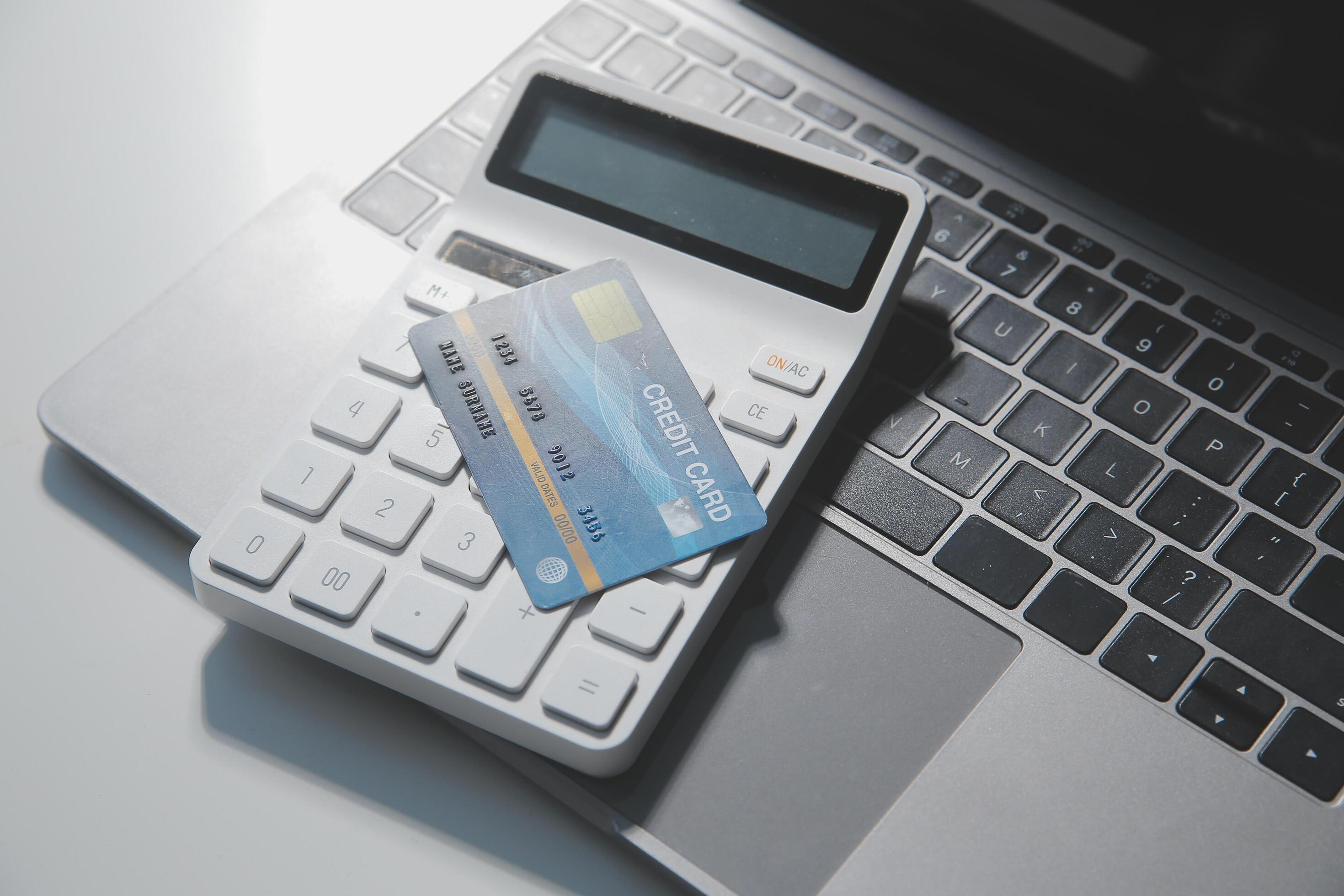 Calculator on a dark background, plastic cards and banknotes Stock Free