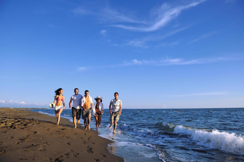 people group running on the beach Stock Free