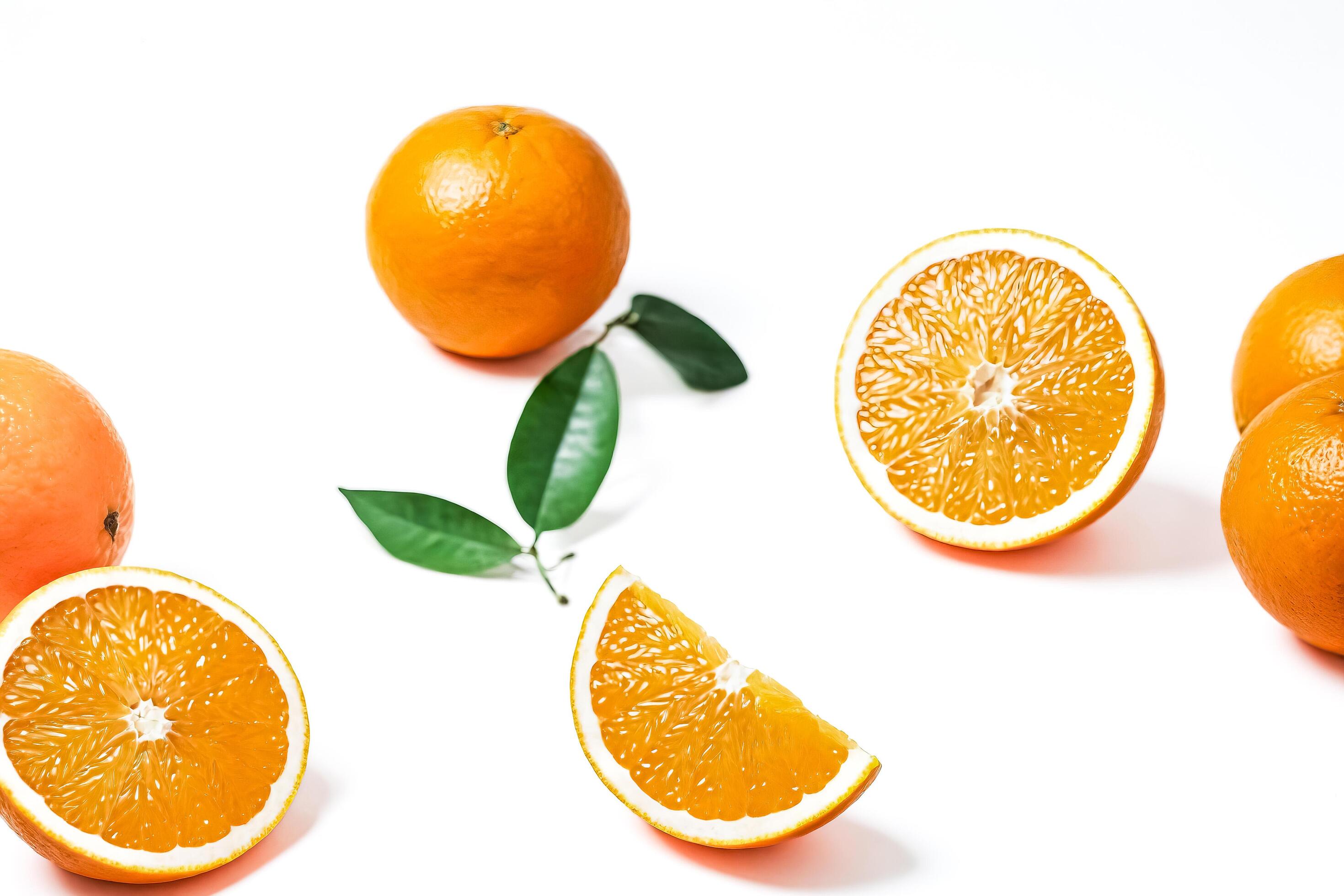 Oranges and orange slices on white background Stock Free