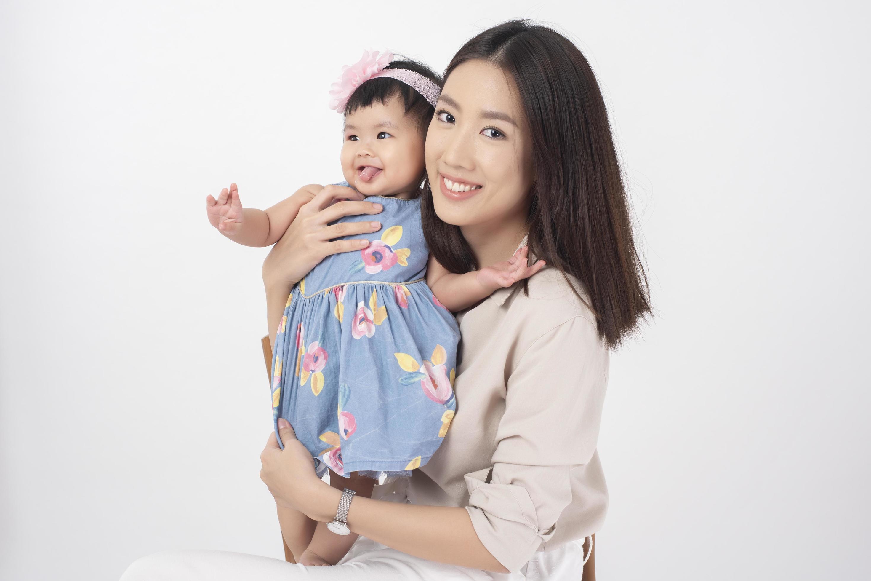 Asian mother and adorable baby girl are happy on white background Stock Free