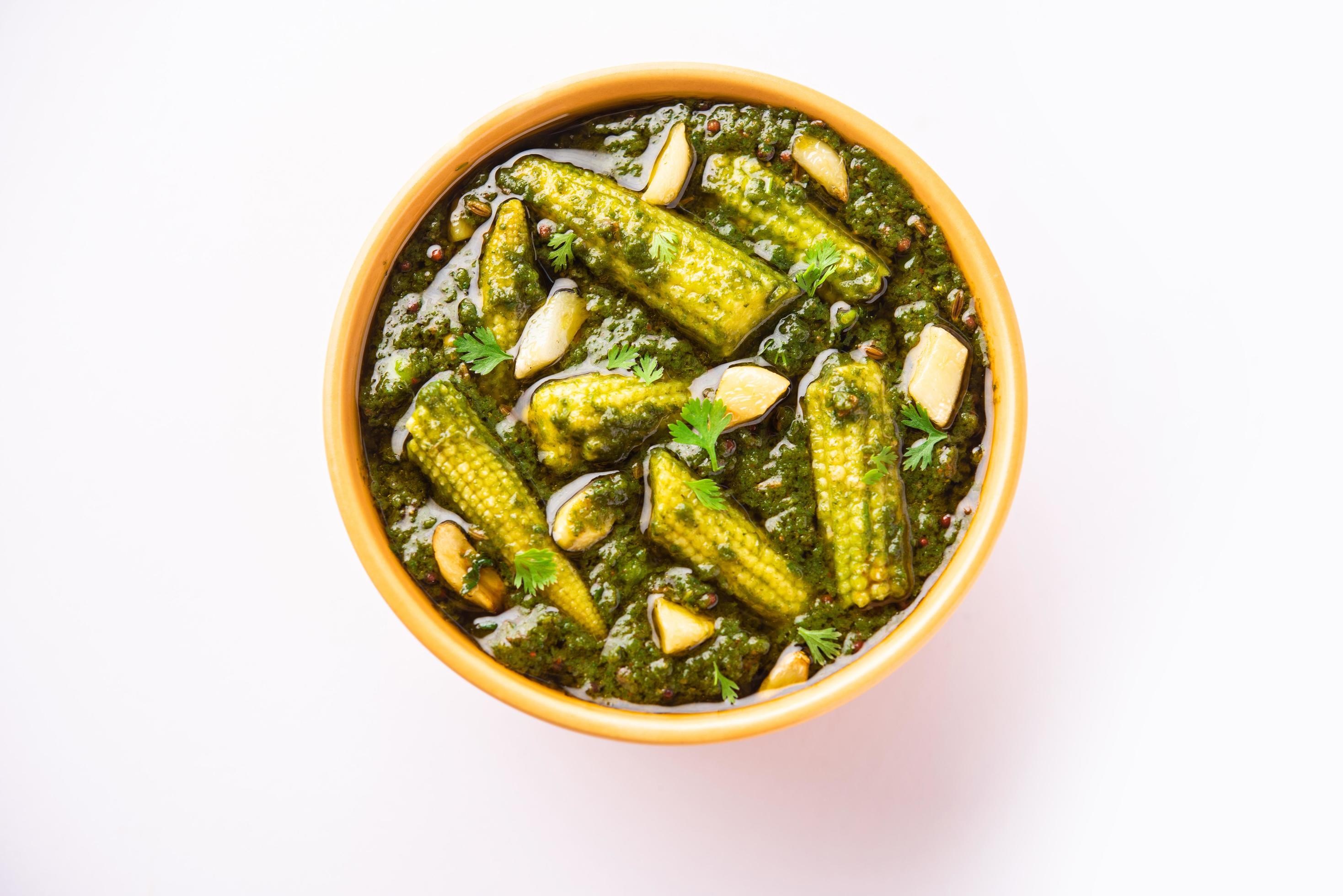 palak baby corn sabzi also known as spinach makai curry served with rice or roti, Indian food Stock Free