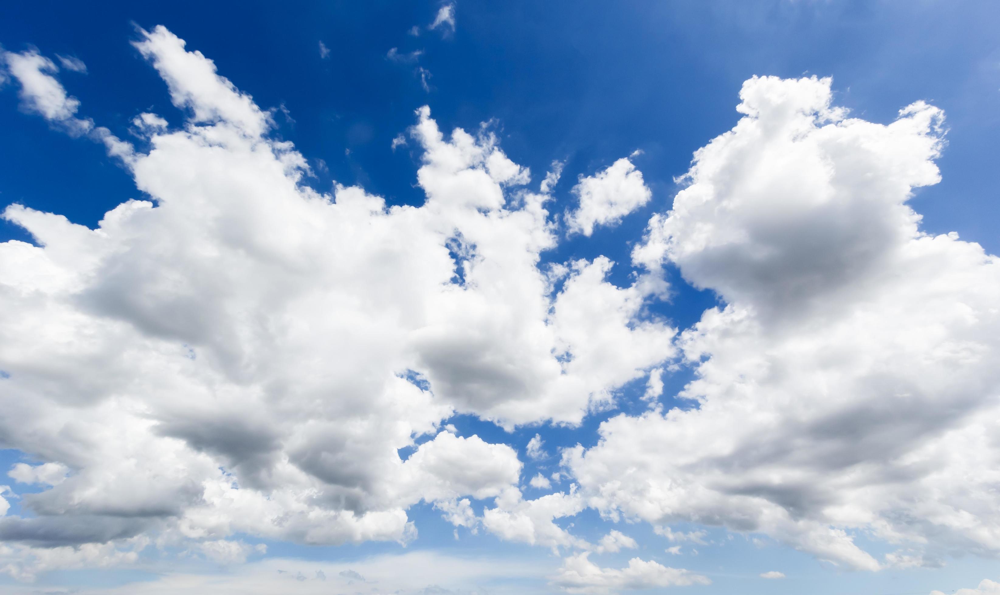 Natural abstract background of bright blue sky and fluffy white clouds on a sunny. Stock Free