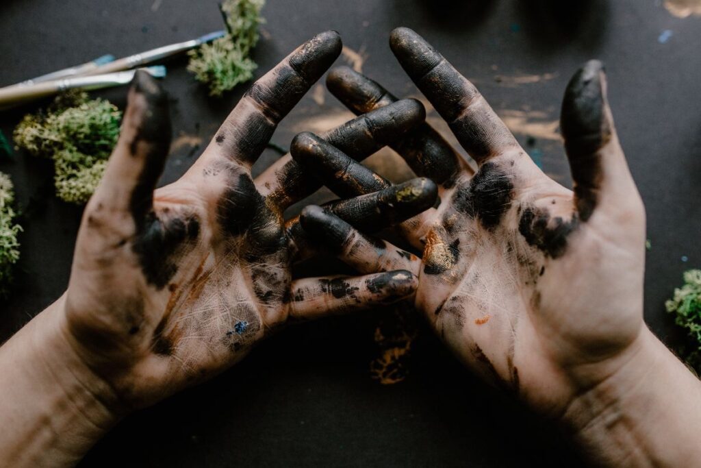 Messy painted hands of a painting artist Stock Free