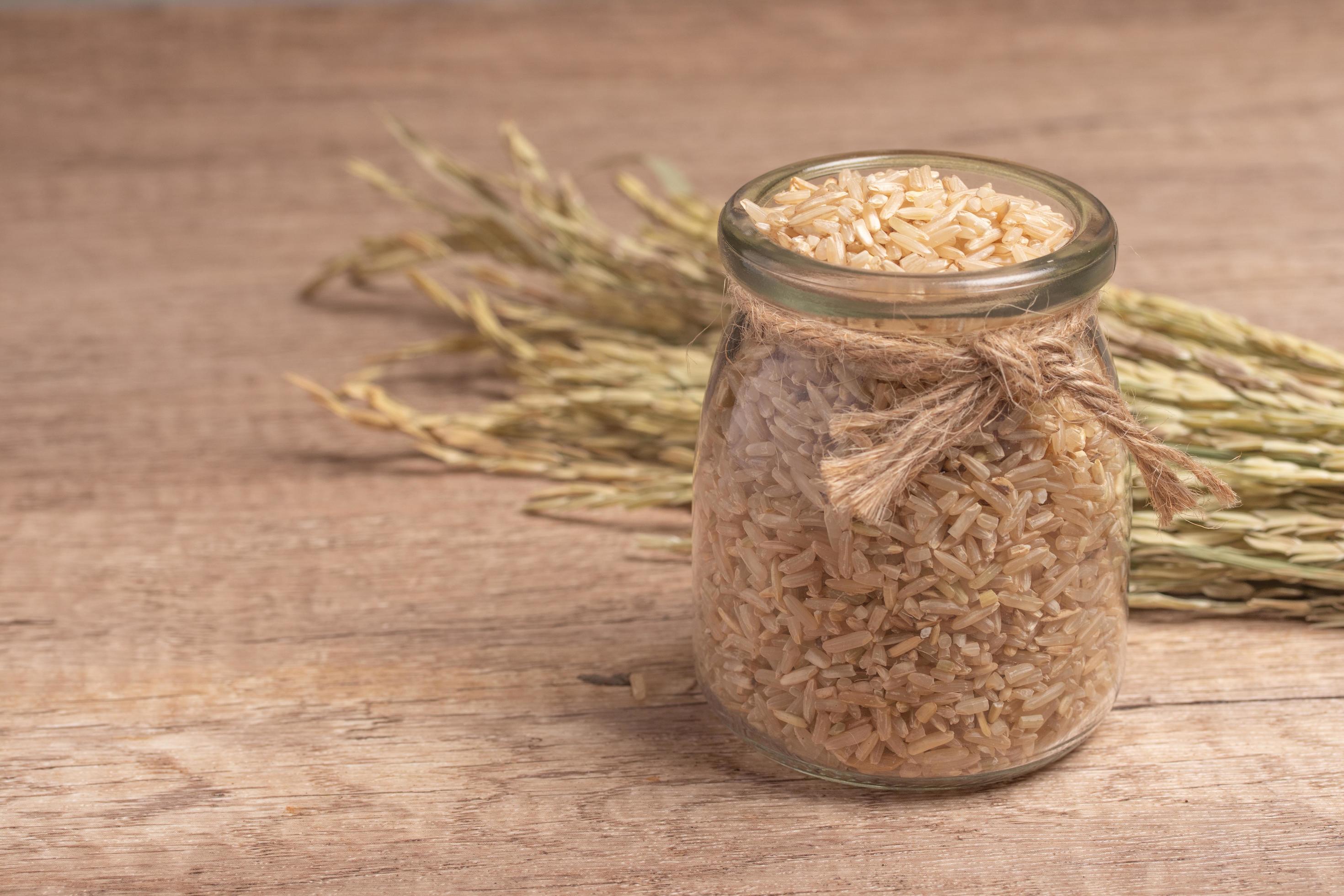 brown Jasmine rice on dark wood background with copy space, healthy food Stock Free