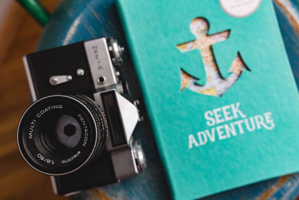 
									Blue notebooks and a camera on a blue wooden stool Stock Free