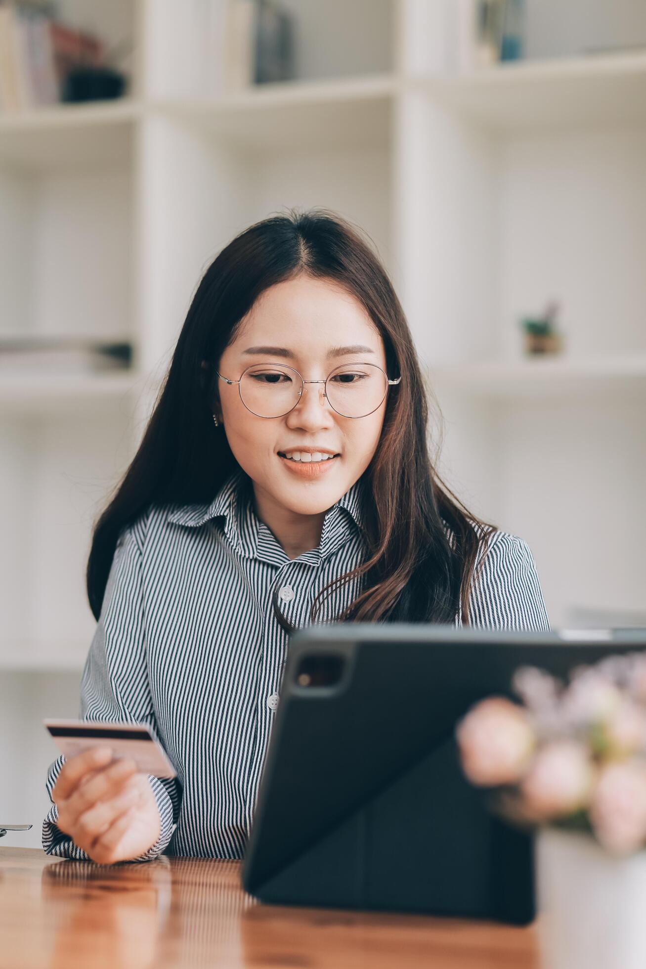 Happy asian woman using smartphone shopping online with credit card. Lifestyle. Easy pay using smart phone or digital device. Stock Free