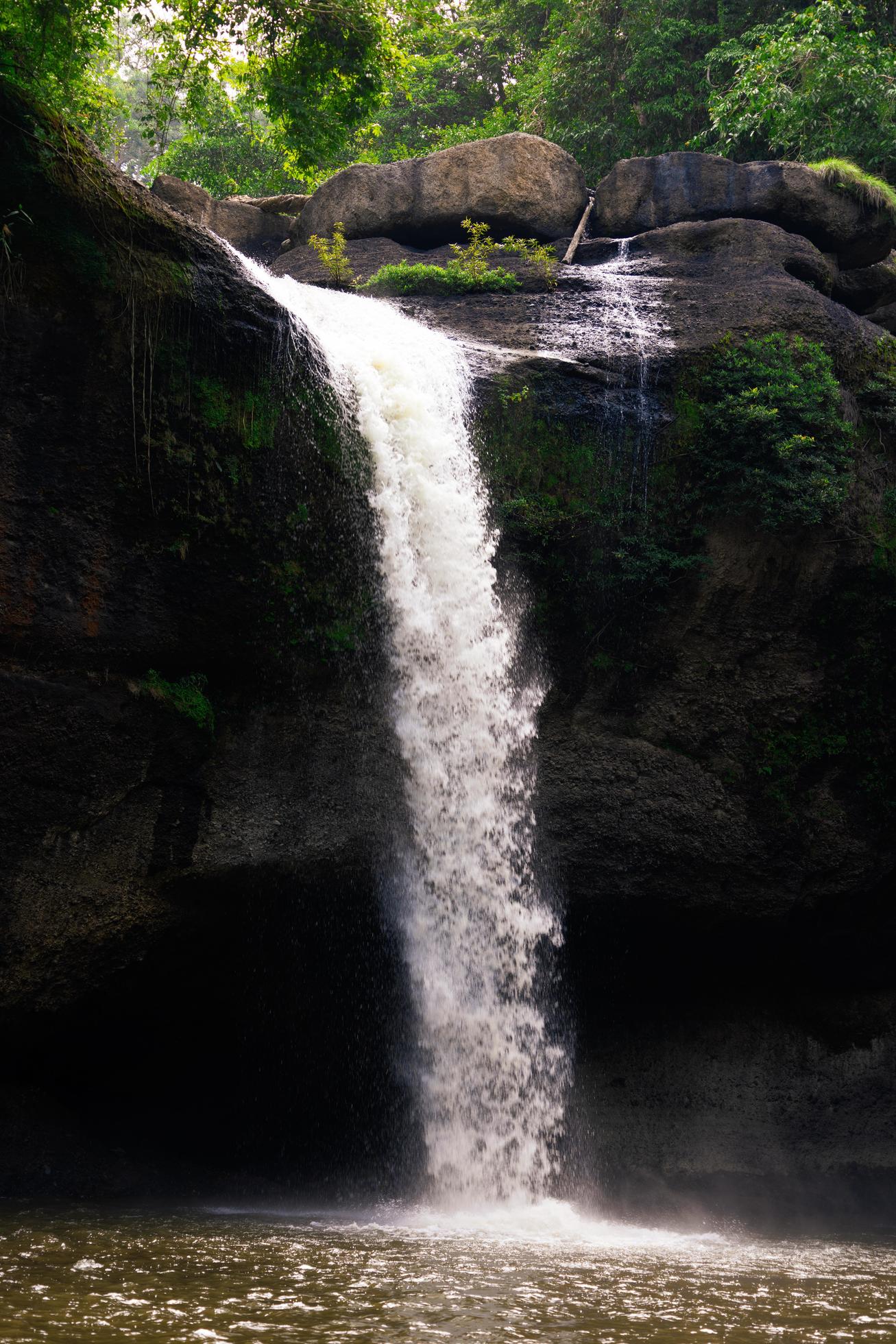 A natural waterfall in a big forest in the midst of beautiful nature. Stock Free