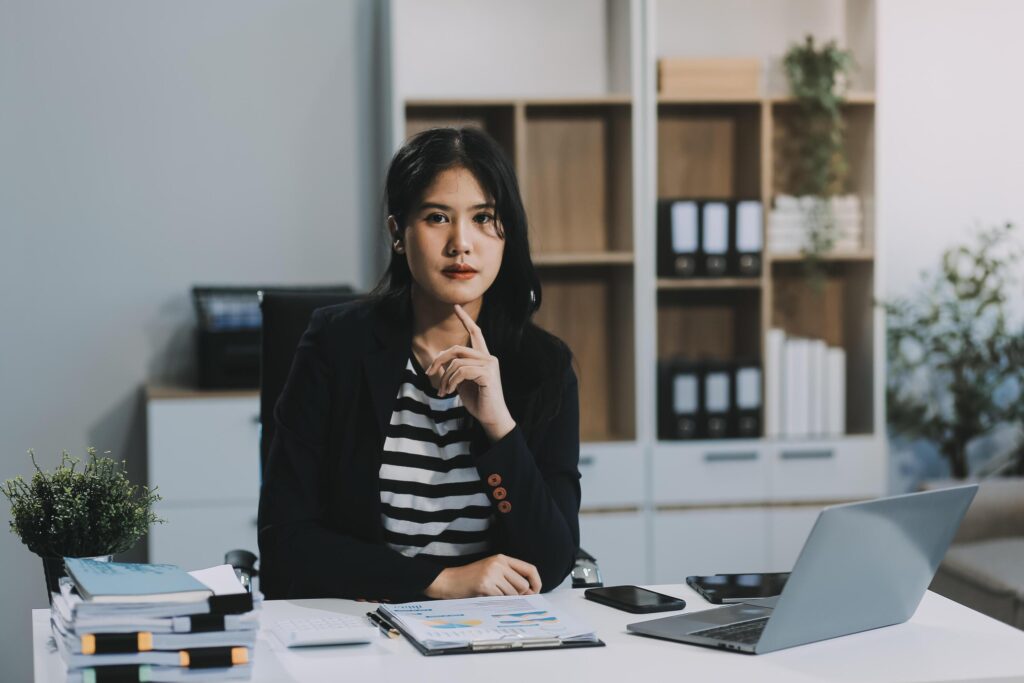 Young pretty business woman with notebook in the office Stock Free