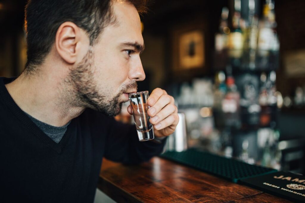 Handsome young man in a pub Stock Free