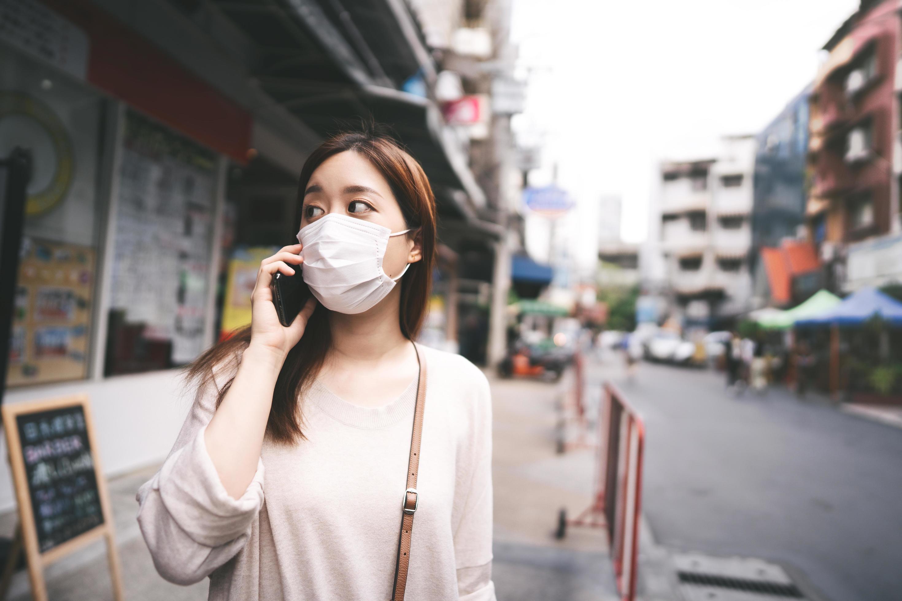 Casual business young asian single woman wear mask for new normal lifestyle in city Stock Free