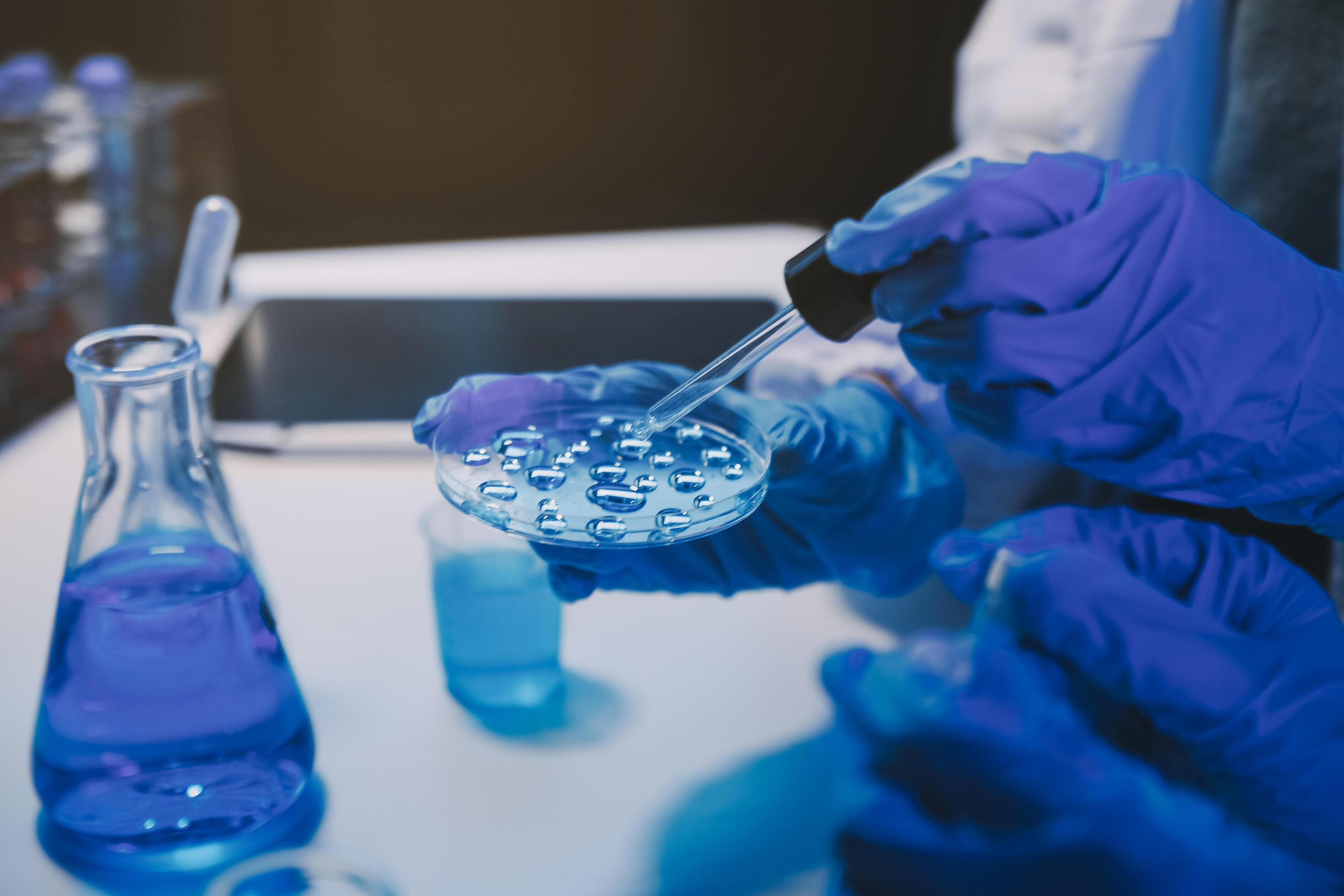 chemist,scientist hand dropping chemical liquid into test tube, science research and development concept Stock Free