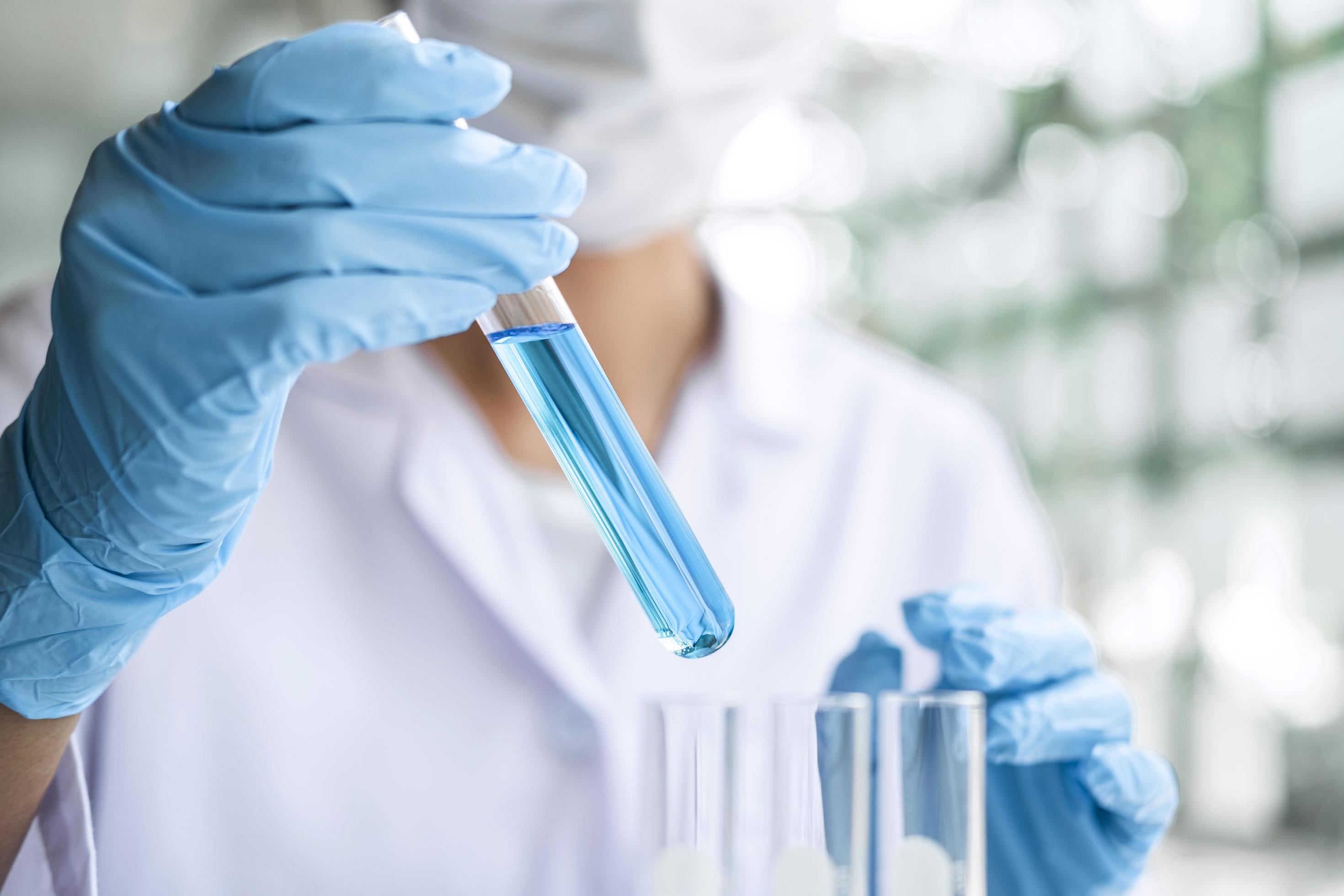 Close-up of a scientist holding a test tube Stock Free